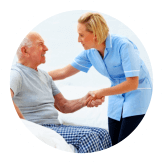 caregiver helping an elderly man stand up